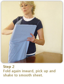 Step 2:
Fold again inward, pick up and shake to smooth sheet.